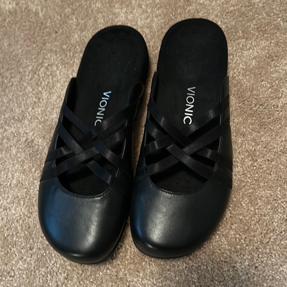 Bionic black leather strappy mules.